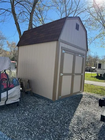 a backyard of a house with barbeque oven