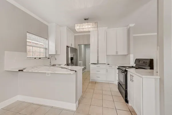a kitchen with a sink a stove and top oven