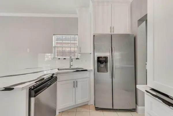 a kitchen with a stove sink and cabinets