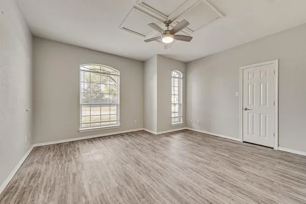 a kitchen with white cabinets and appliances