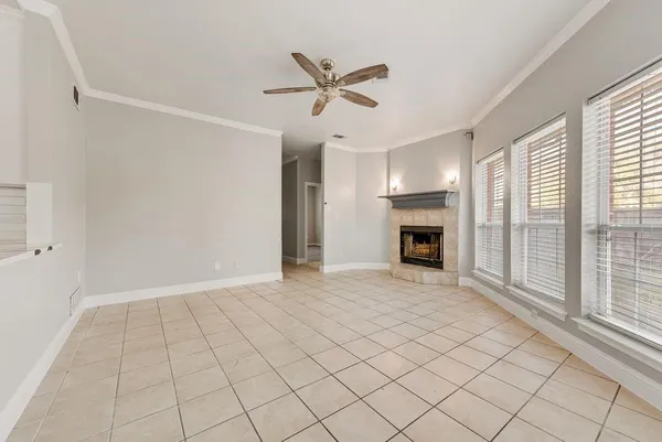 a view of an empty room with a fireplace and a window