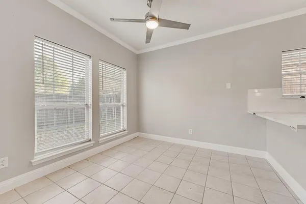 a view of an empty room with a fireplace and a window