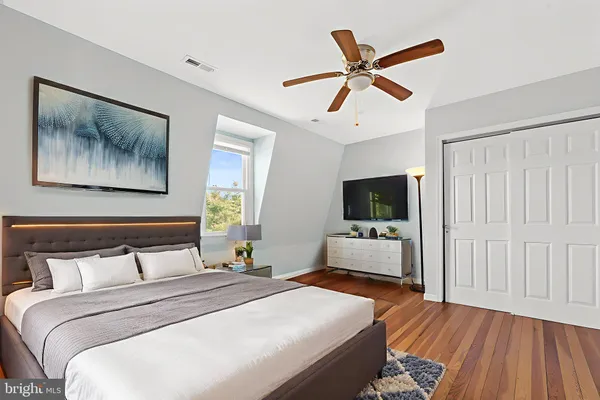 a bedroom with a bed and a flat screen tv