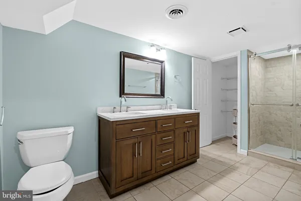 a bathroom with a toilet sink and shower