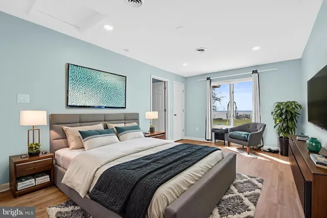 a bedroom with bed and a potted plant