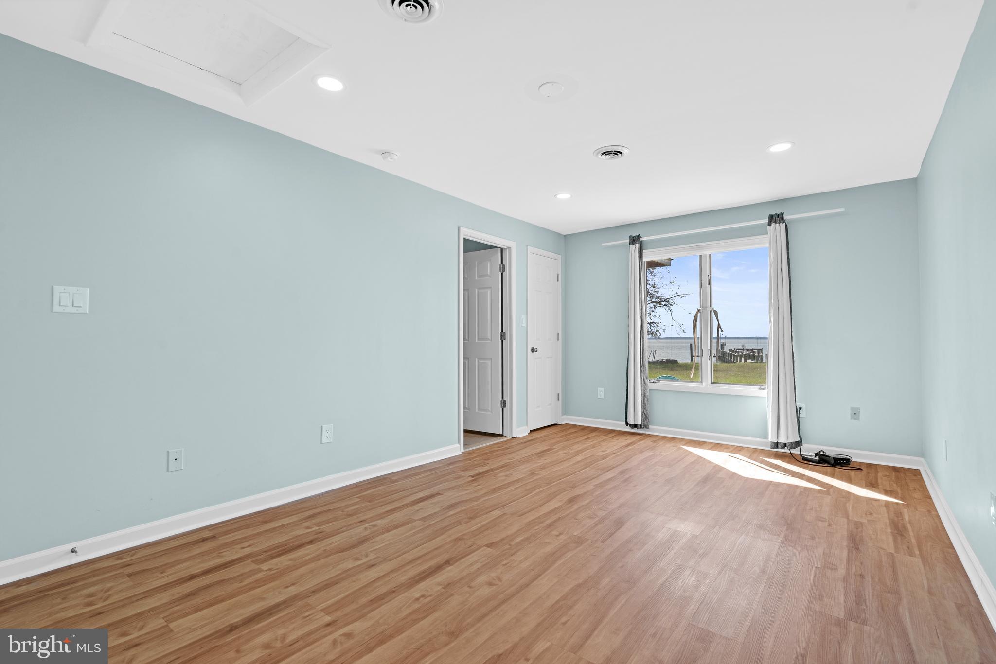 17203 Piney Point Road Piney Point, MD 20674 - Photo 20 of 43 a view of an empty room with wooden floor