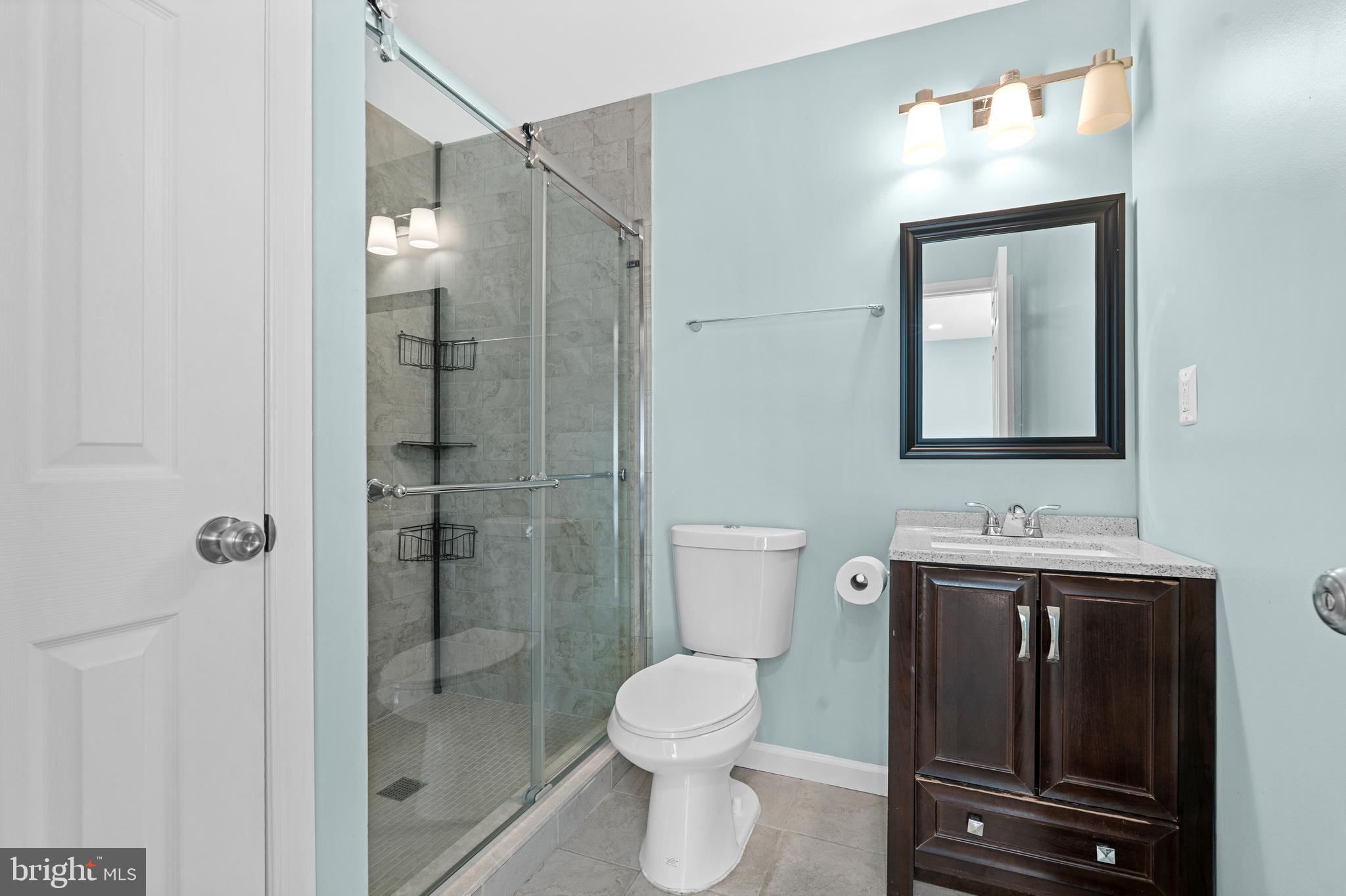 17203 Piney Point Road Piney Point, MD 20674 - Photo 21 of 43 a bathroom with a toilet sink vanity granite and shower