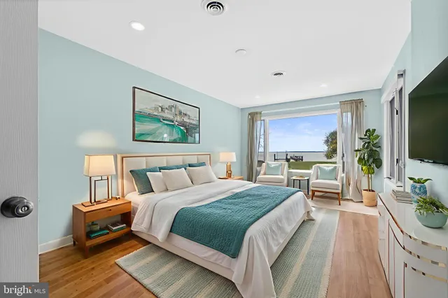 a spacious bedroom with a bed and a flat screen tv