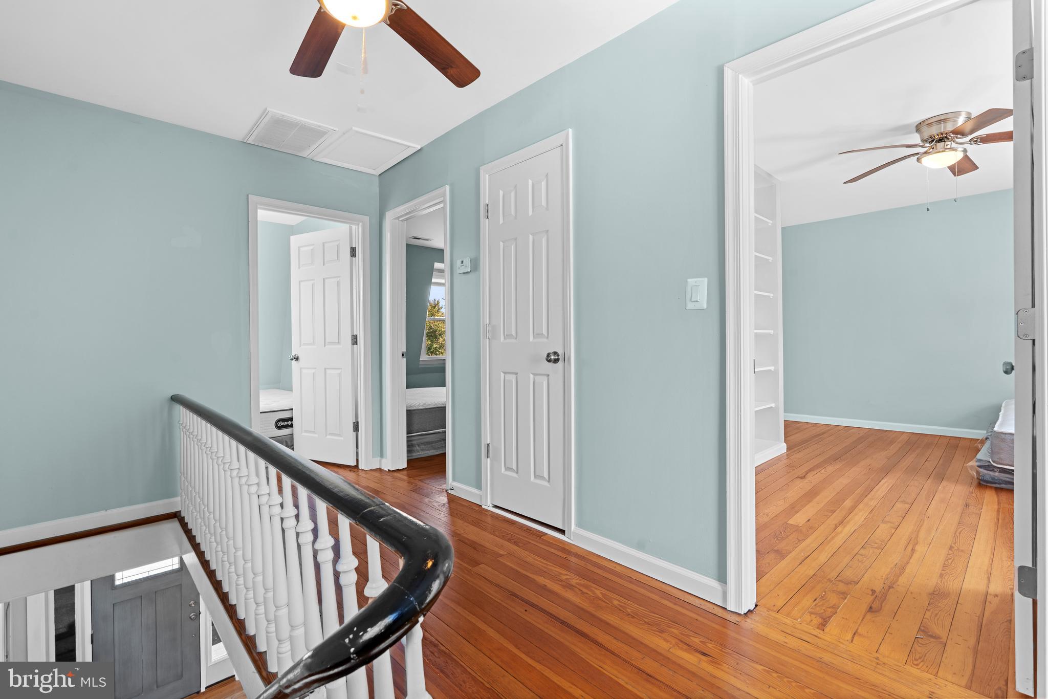 17203 Piney Point Road Piney Point, MD 20674 - Photo 24 of 43 a view of a hallway with wooden floor and staircase