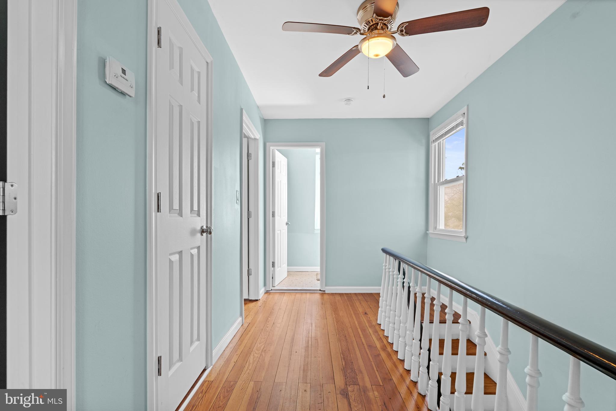17203 Piney Point Road Piney Point, MD 20674 - Photo 28 of 43 a view of a hallway with a chandelier fan