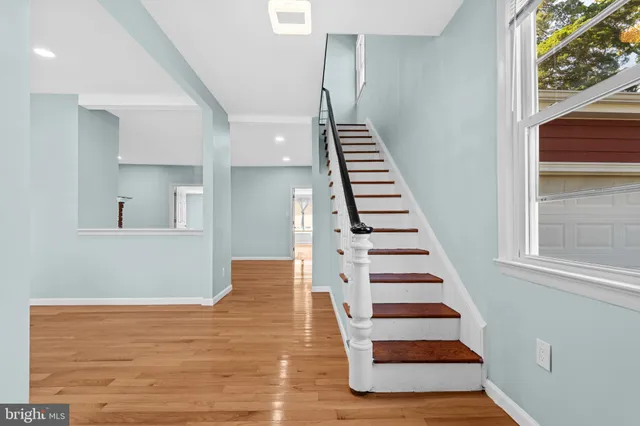a view of entryway and hall with wooden floor
