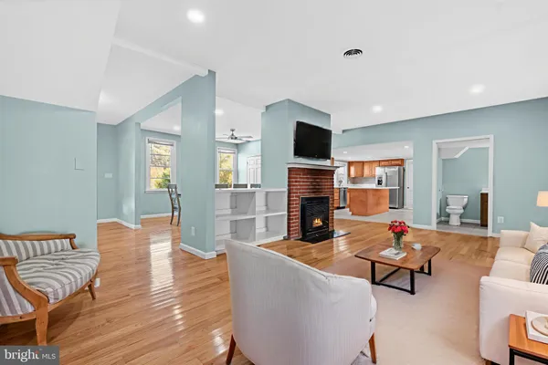a living room with fireplace furniture and a flat screen tv
