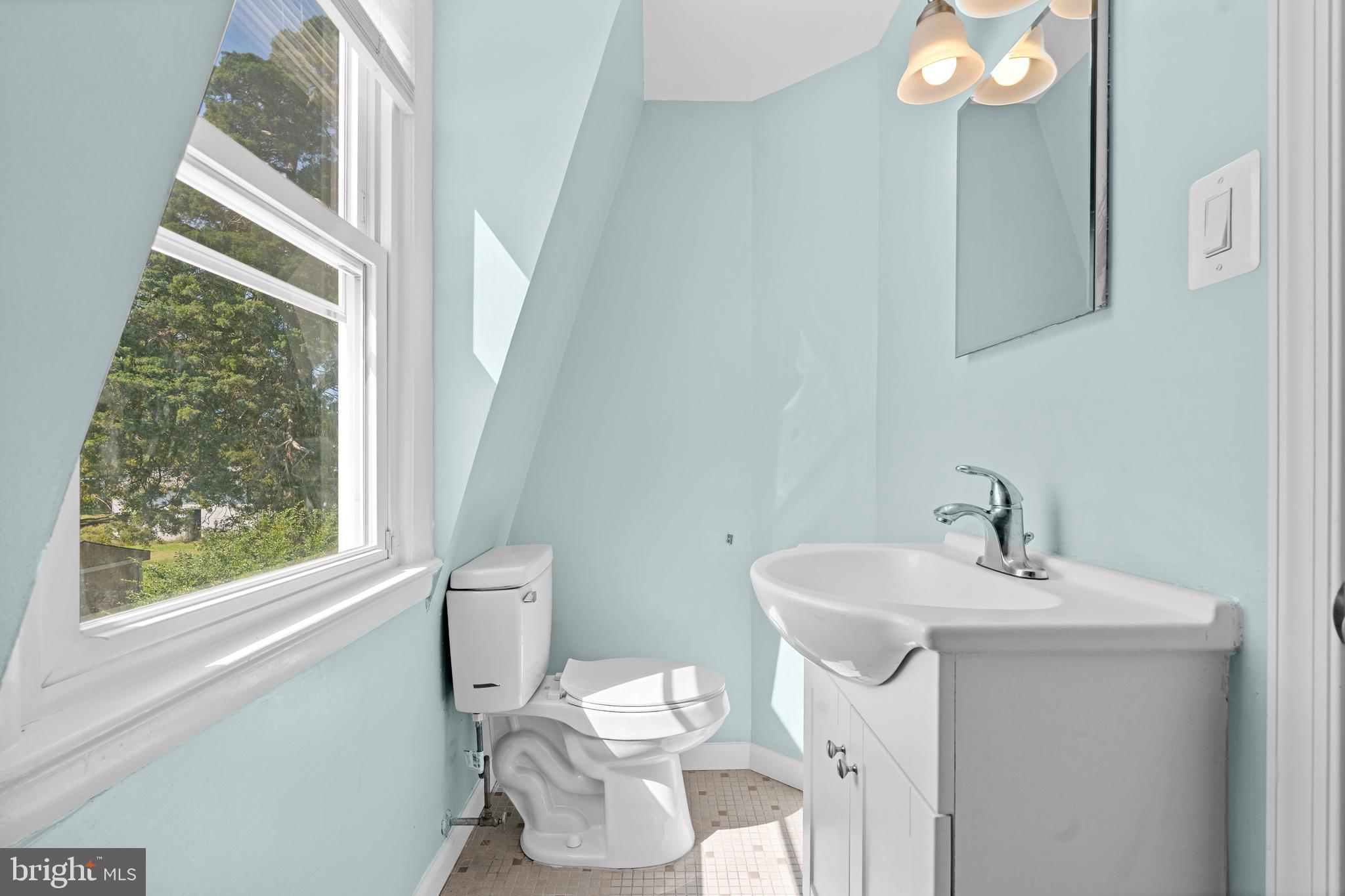 17203 Piney Point Road Piney Point, MD 20674 - Photo 31 of 43 a bathroom with a sink a toilet and a mirror