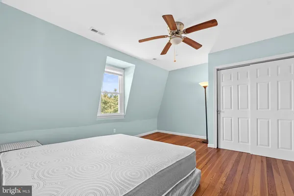 a bedroom with a large bed and a window