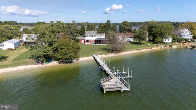 a view of a lake with lawn chairs