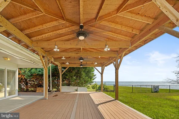 a view of a patio with a table and chairs under an umbrella