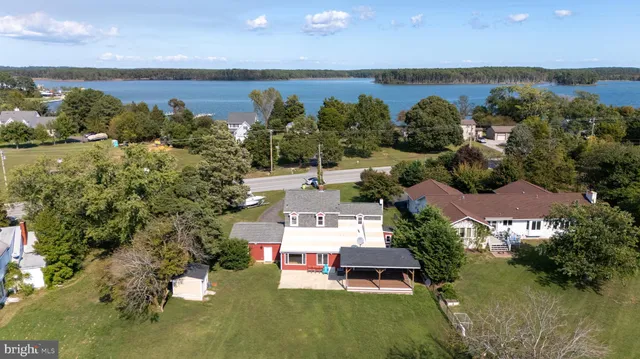 an aerial view of a house with garden space and street view