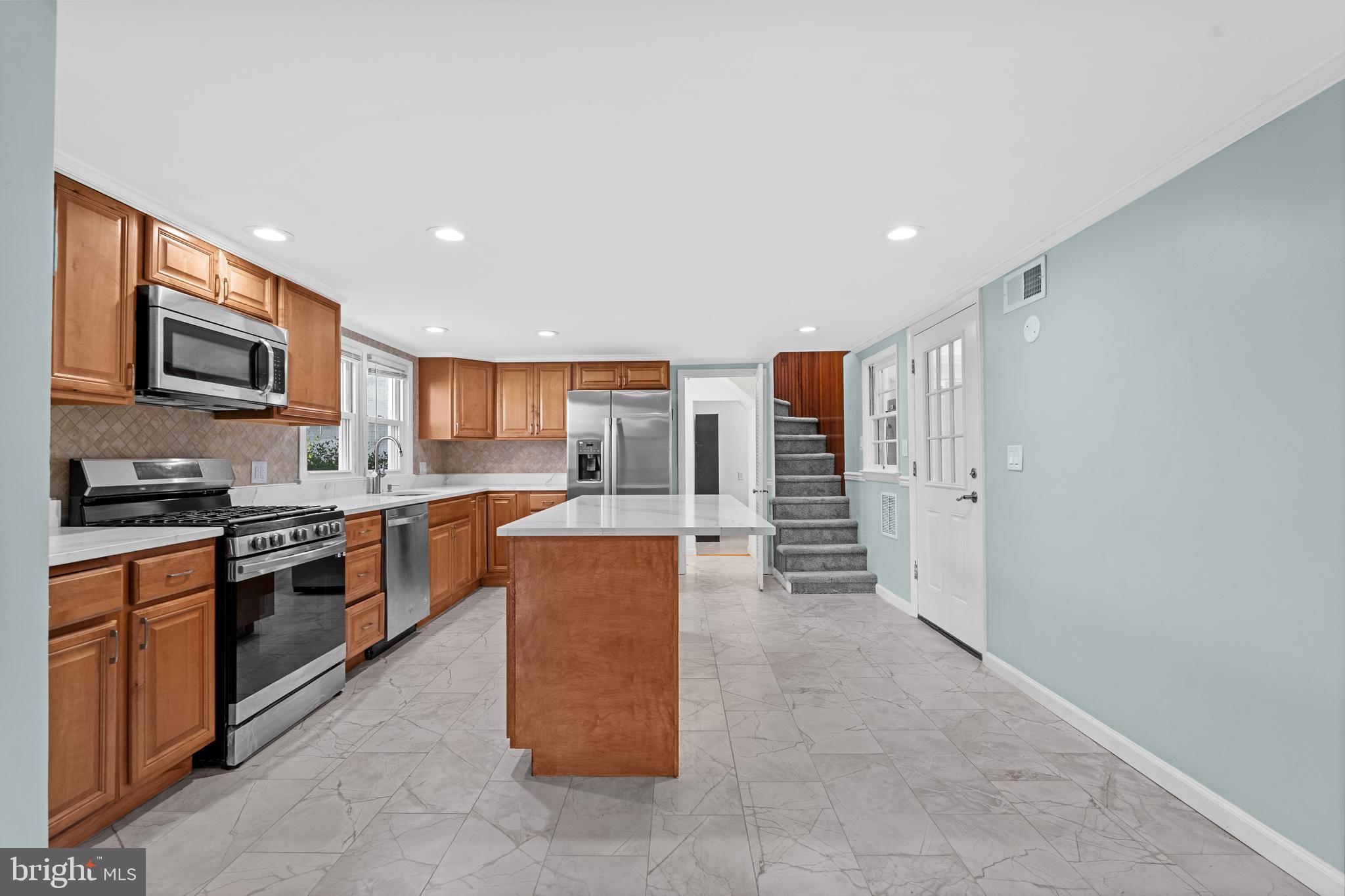 17203 Piney Point Road Piney Point, MD 20674 - Photo 6 of 43 a large kitchen with stainless steel appliances granite countertop a stove top oven a sink and a refrigerator