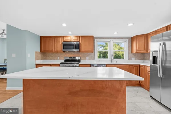 a view of kitchen with stainless steel appliances granite countertop a sink a stove and a refrigerator