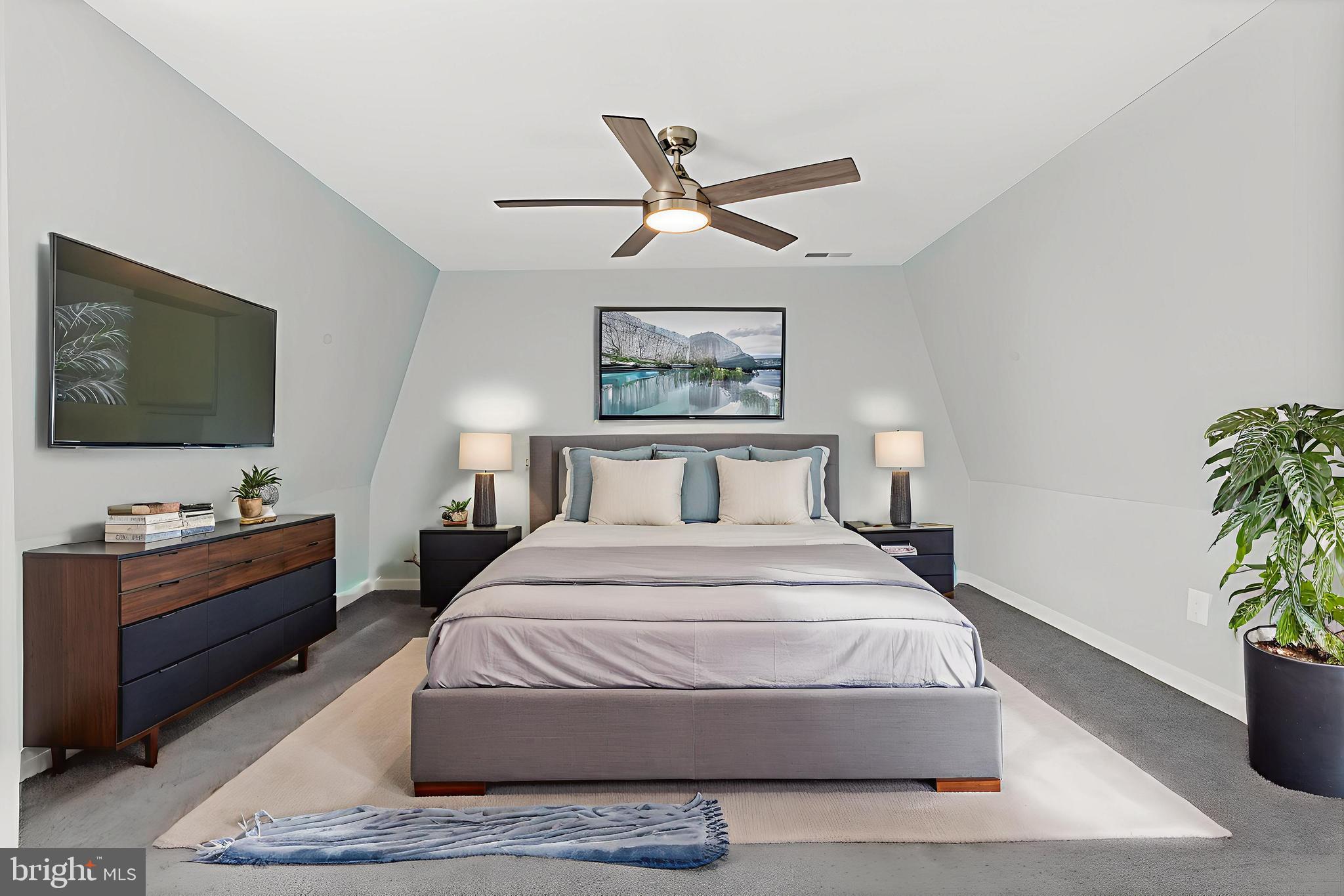 17203 Piney Point Road Piney Point, MD 20674 - Photo 10 of 43 a bedroom with a bed and a flat screen tv