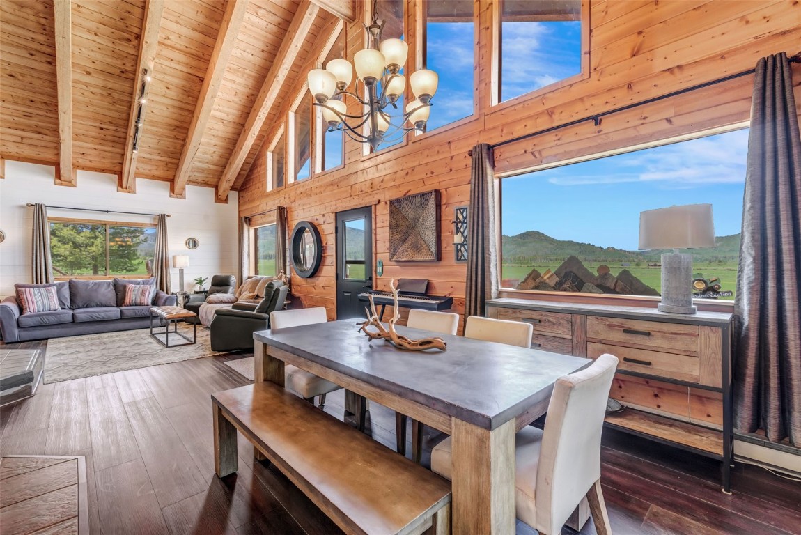 60455 Floyd Creek Road Clark, CO 80428 - Photo 12 of 50 a view of a dining room with furniture window and wooden floor