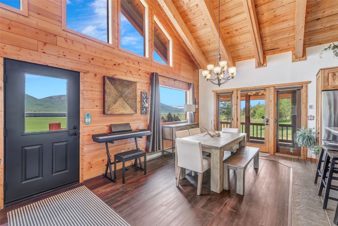 60455 Floyd Creek Road Clark, CO 80428 - Photo 14 of 50 a view of a dining room with furniture window and wooden floor