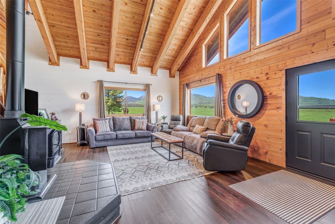 60455 Floyd Creek Road Clark, CO 80428 - Photo 15 of 50 a living room with furniture a clock on wall and a window