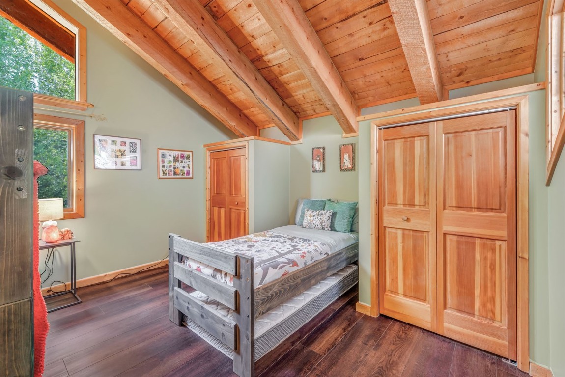 60455 Floyd Creek Road Clark, CO 80428 - Photo 28 of 50 a bedroom with a bed and a dresser next to a window