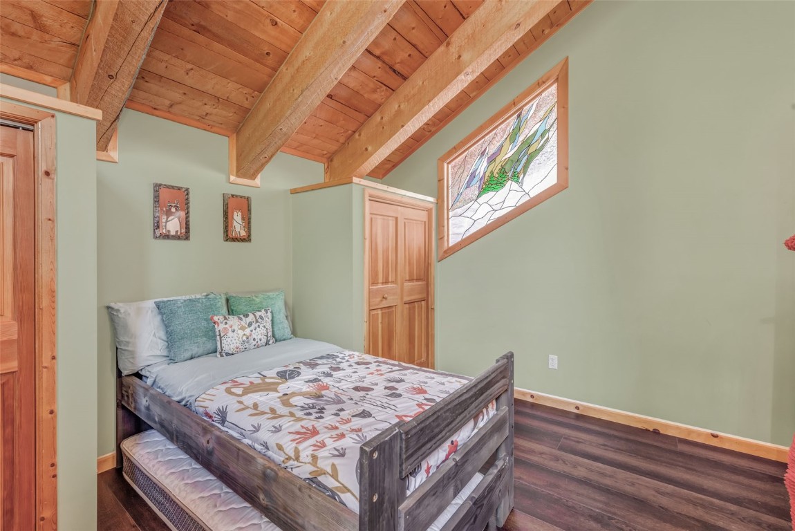 60455 Floyd Creek Road Clark, CO 80428 - Photo 31 of 50 a bedroom with a bed and wooden floor