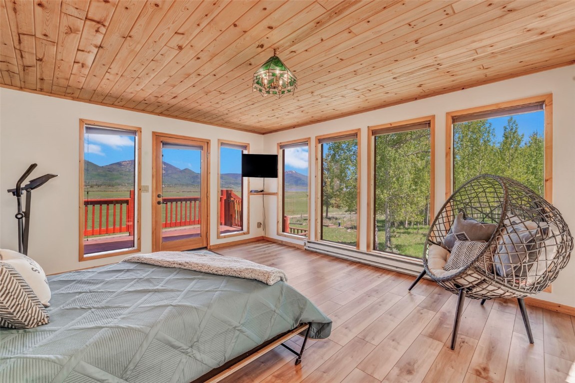 60455 Floyd Creek Road Clark, CO 80428 - Photo 39 of 50 a bedroom with a bed and wooden floor