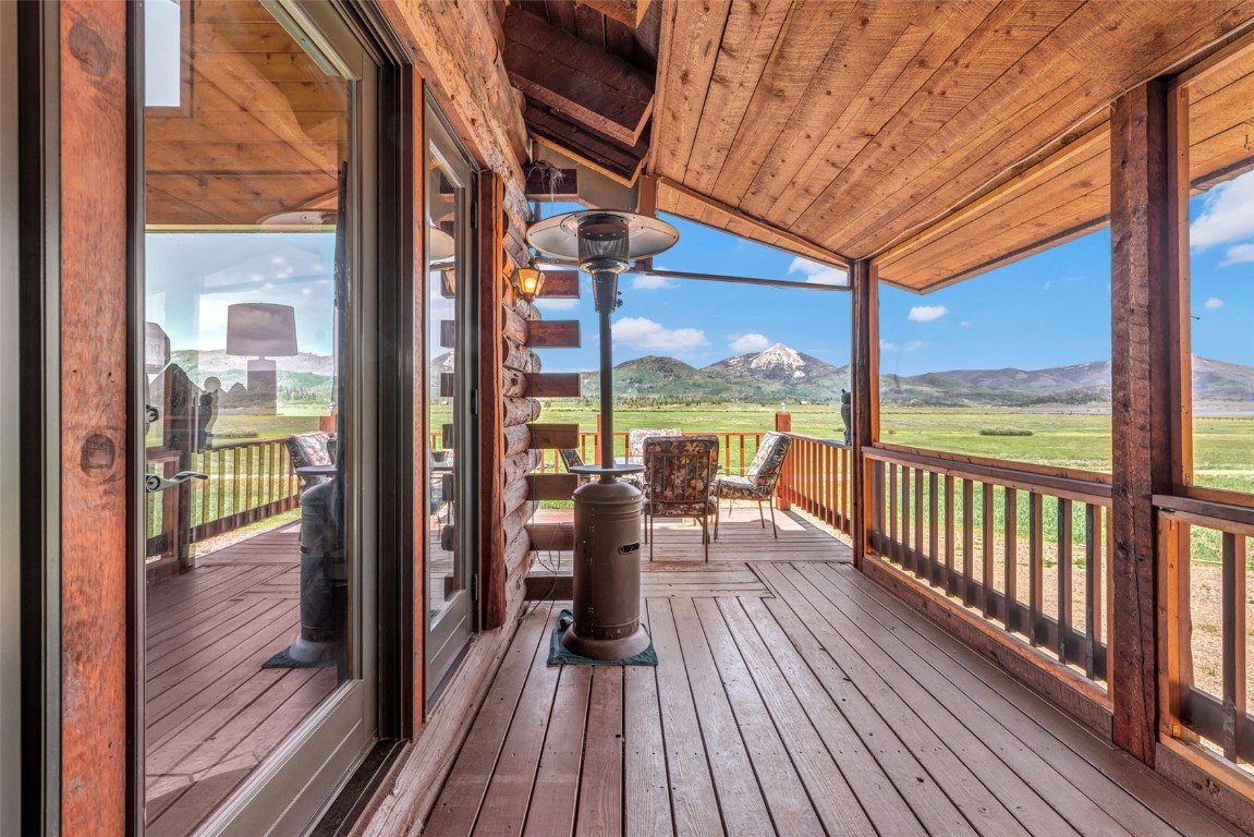60455 Floyd Creek Road Clark, CO 80428 - Photo 42 of 50 a view of a balcony with chairs and wooden floor