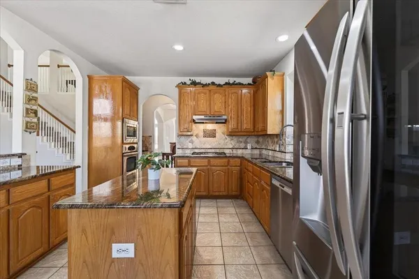 a living room with furniture and kitchen view