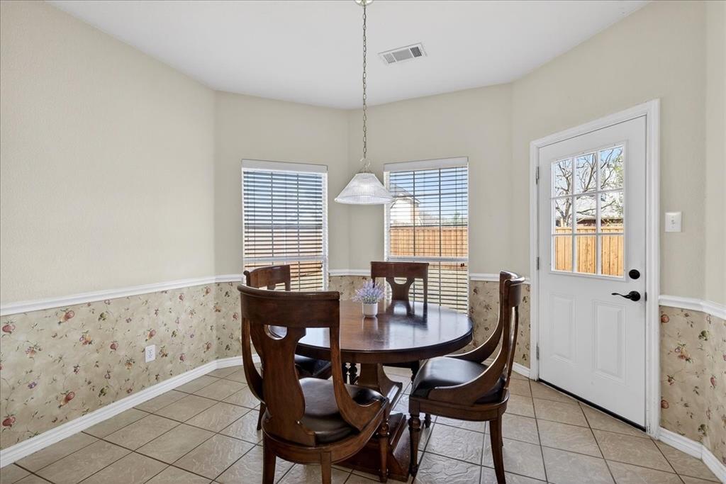 7308 Hawk Lane Sachse, TX 75048 - Photo 15 of 37 a view of a dining room with furniture and window