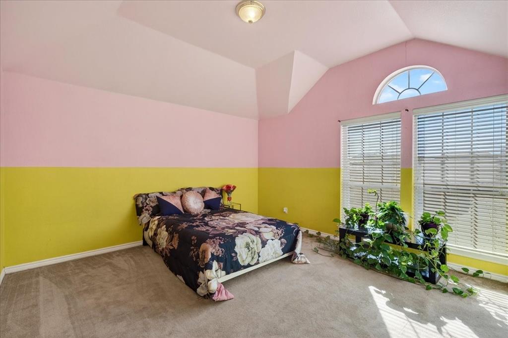 7308 Hawk Lane Sachse, TX 75048 - Photo 26 of 37 a bedroom with a bed and a potted plant