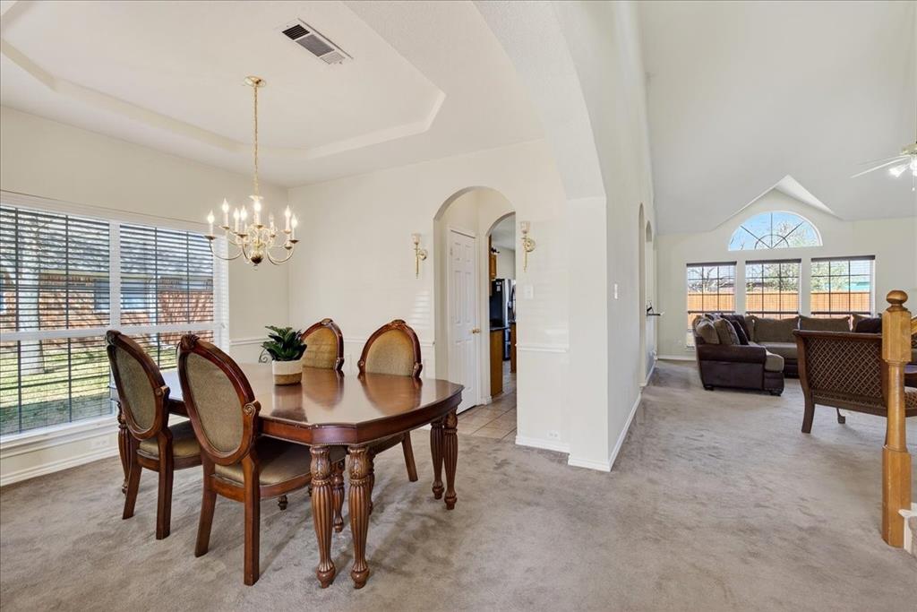 7308 Hawk Lane Sachse, TX 75048 - Photo 8 of 37 a dining room with furniture a chandelier and window