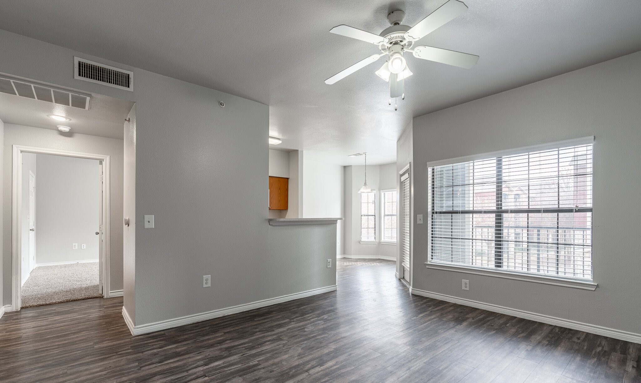 1350 Skyline Road Grand Prairie, TX 75051 - Photo 8 of 10 a view of an empty room with window and wooden floor
