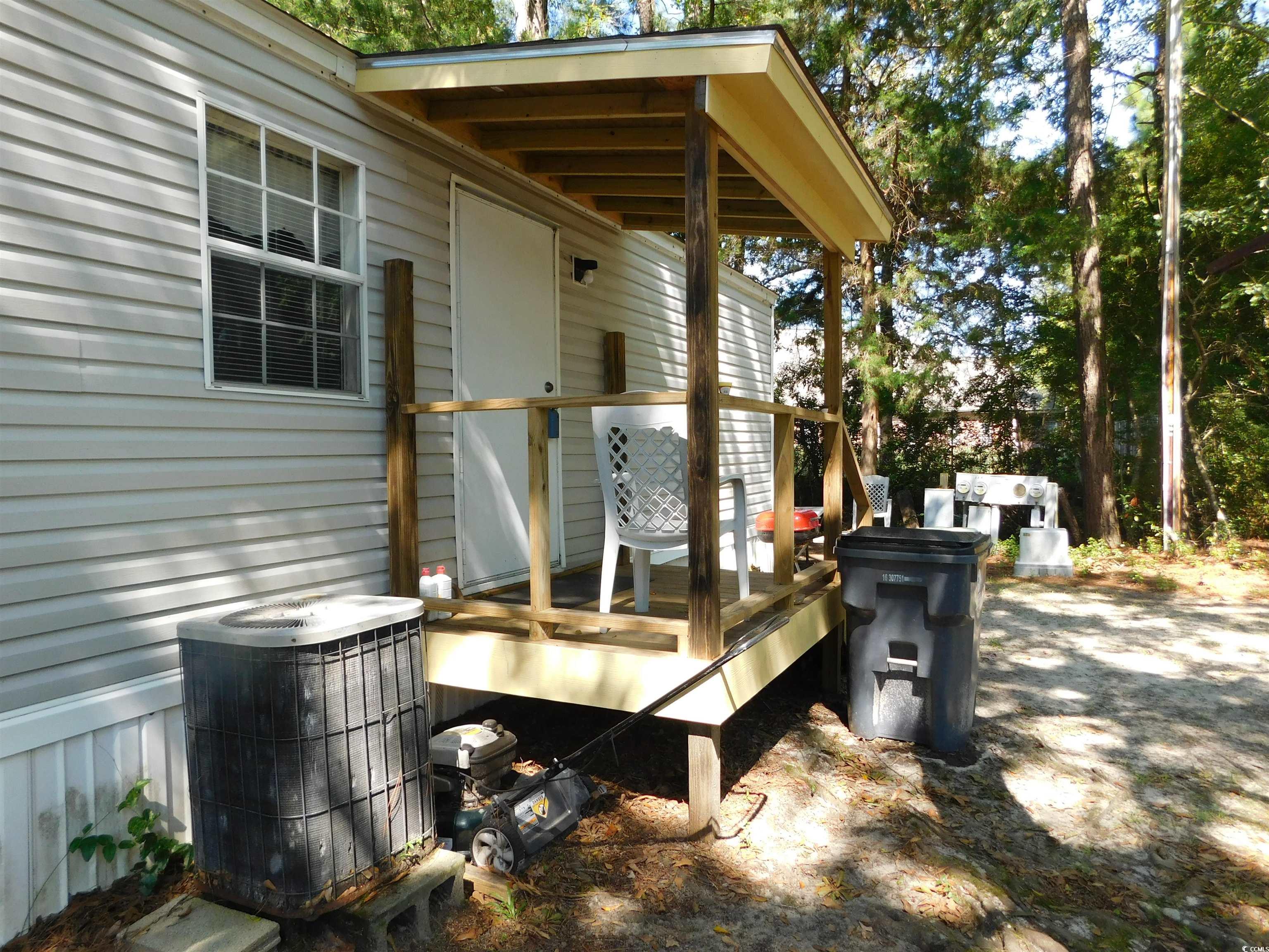 112 Offshore Drive Murrells Inlet, SC 29576 - Photo 4 of 14 Wooden terrace featuring central AC unit