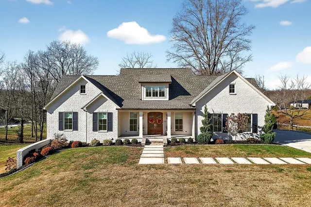 a front view of a house with a yard and garage