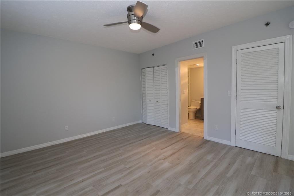 2950 Southeast Ocean Boulevard, Unit 101 Stuart, FL 34996 - Photo 15 of 35 a view of an empty room with wooden floor