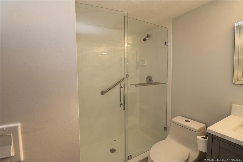 2950 Southeast Ocean Boulevard, Unit 101 Stuart, FL 34996 - Photo 18 of 35 a bathroom with a toilet and a shower