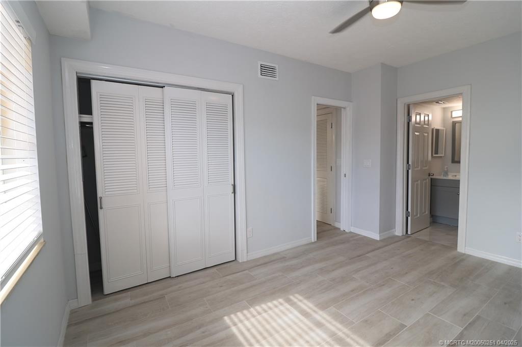 2950 Southeast Ocean Boulevard, Unit 101 Stuart, FL 34996 - Photo 22 of 35 an empty room with window and closet area