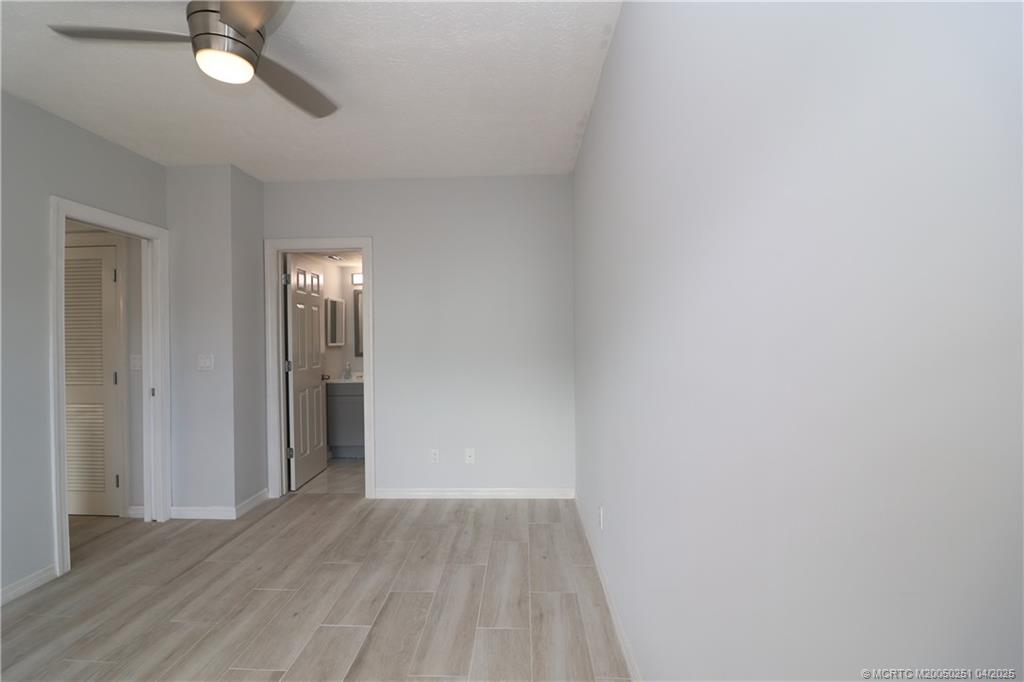 2950 Southeast Ocean Boulevard, Unit 101 Stuart, FL 34996 - Photo 23 of 35 a view of an empty room and wooden floor