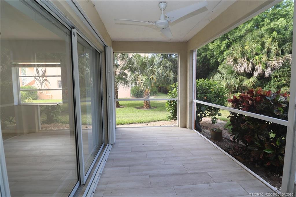 2950 Southeast Ocean Boulevard, Unit 101 Stuart, FL 34996 - Photo 27 of 35 a view of porch with a floor to ceiling window and wooden floor