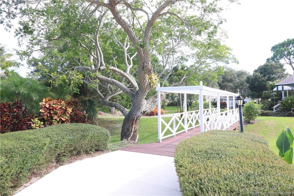 2950 Southeast Ocean Boulevard, Unit 101 Stuart, FL 34996 - Photo 35 of 35 a front view of a house with a yard