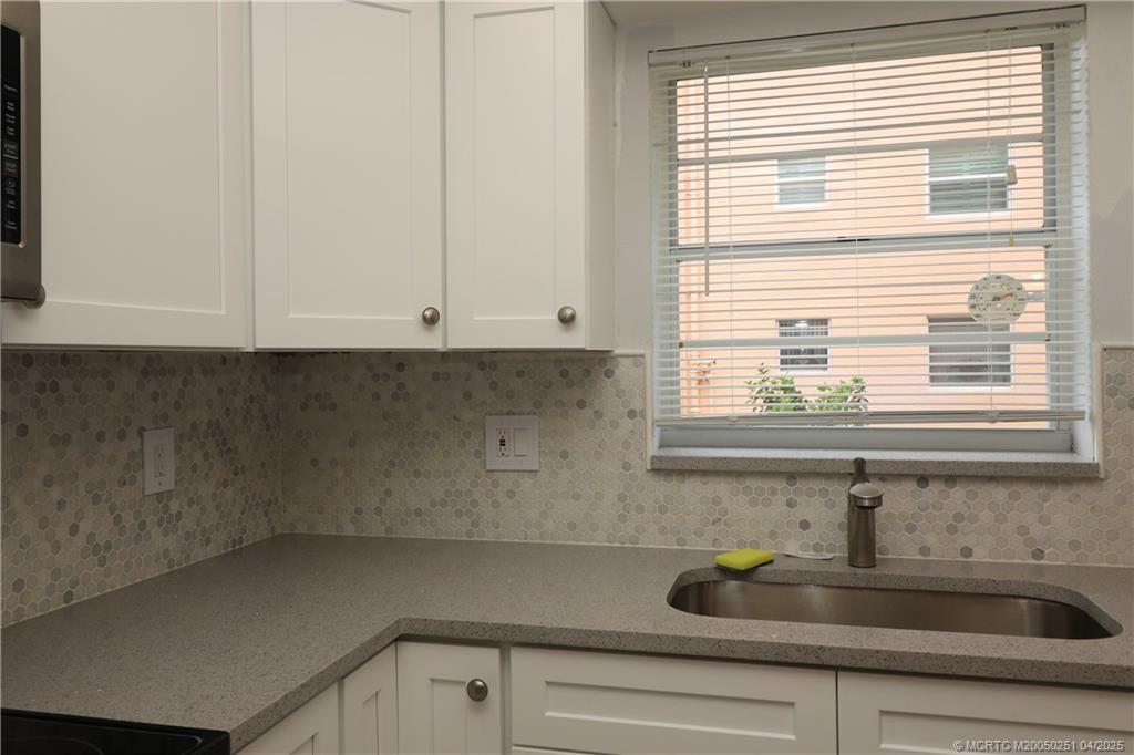 2950 Southeast Ocean Boulevard, Unit 101 Stuart, FL 34996 - Photo 7 of 35 a kitchen with a sink and a window