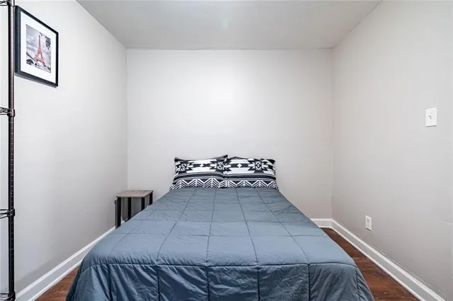 a view of a bedroom with wooden floor