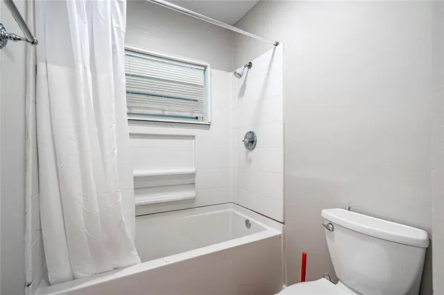 a bathroom with a toilet and a bathtub