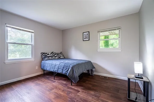a bed sitting in a bedroom next to a window