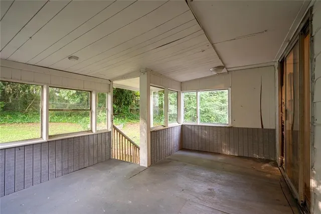 an empty room with large windows