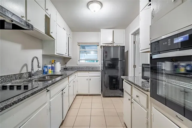 a kitchen with a sink stove and refrigerator